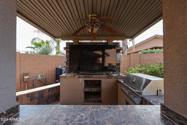 view of patio featuring a grill, an outdoor kitchen, and ceiling fan