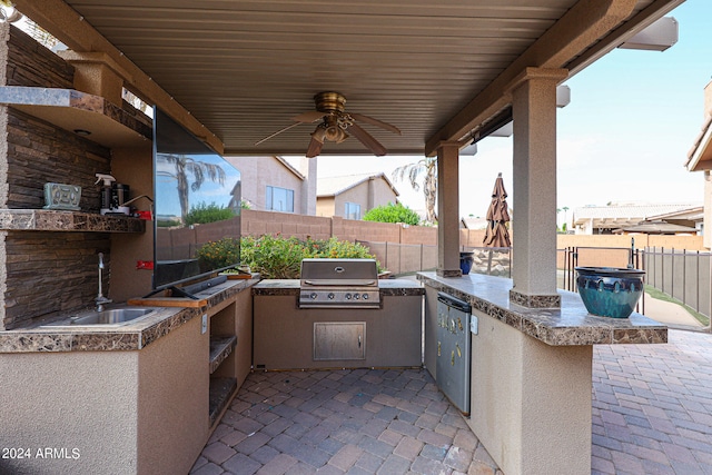 view of patio / terrace featuring ceiling fan, area for grilling, sink, and a grill