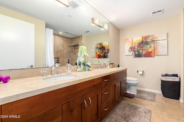 bathroom with tile patterned flooring, curtained shower, vanity, and toilet