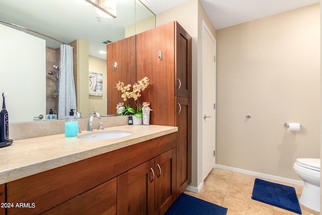 bathroom featuring vanity, tile patterned flooring, and toilet