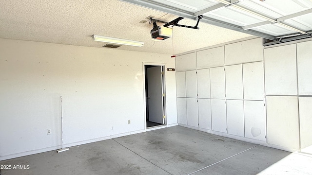 garage featuring visible vents and a garage door opener