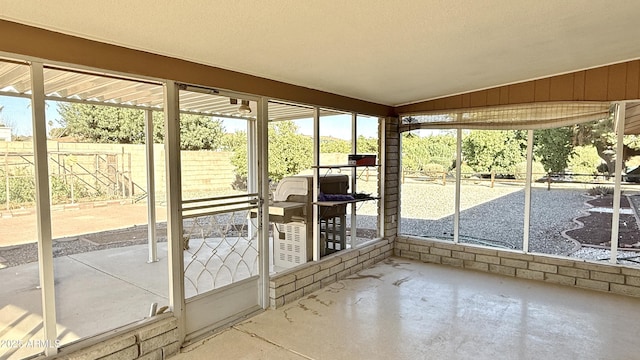 unfurnished sunroom with lofted ceiling