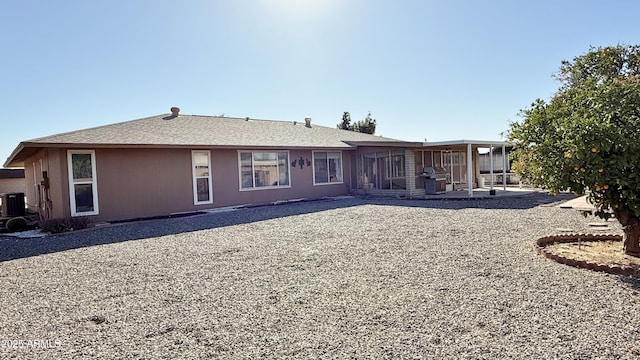 back of property with a patio area and central AC