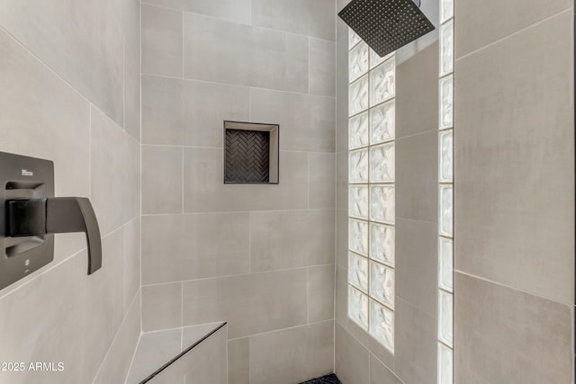 bathroom with a tile shower