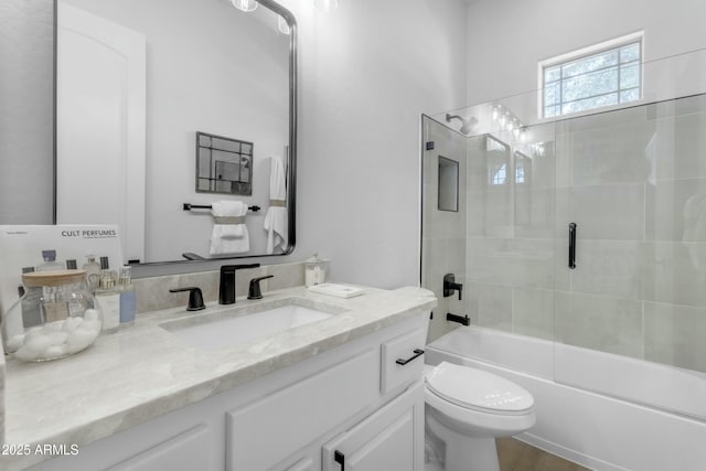 full bathroom featuring vanity, toilet, and bath / shower combo with glass door