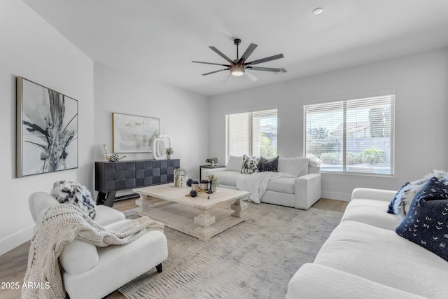 living room with light wood-type flooring and ceiling fan