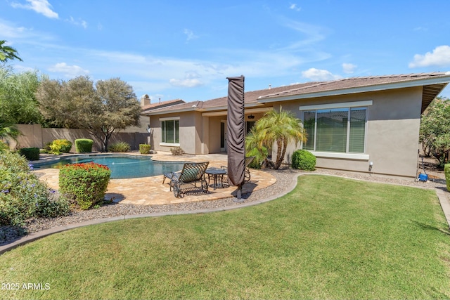 view of swimming pool featuring a patio and a lawn