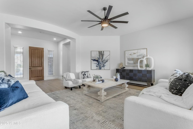 living room featuring ceiling fan and light wood-type flooring