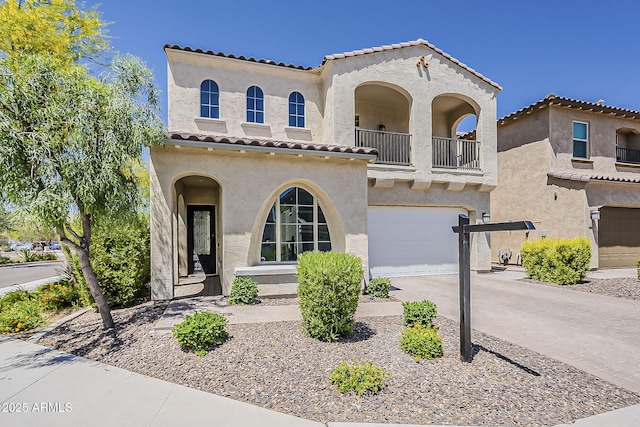 3310 E Los Gatos Dr, Phoenix, AZ 85050 - mediterranean / spanish house with a balcony, stucco siding, an attached garage, a tile roof, and concrete driveway