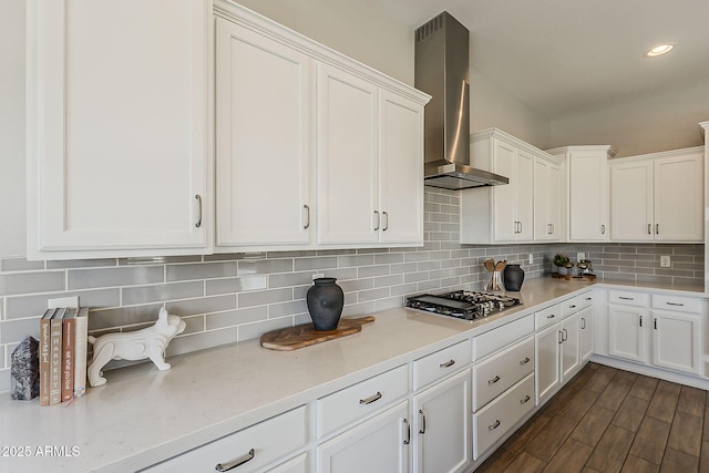 3310 E Los Gatos Dr, Phoenix, AZ 85050 - kitchen with stainless steel gas cooktop, wall chimney exhaust hood, white cabinets, tasteful backsplash, and recessed lighting