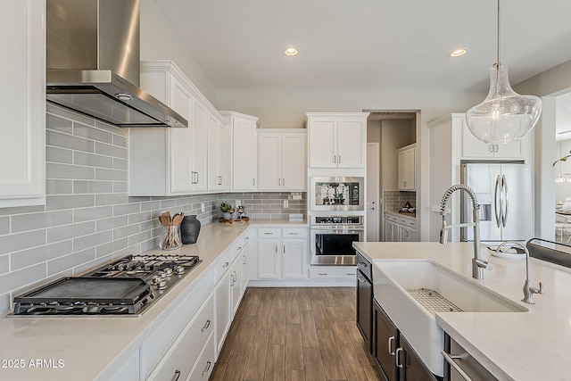 3310 E Los Gatos Dr, Phoenix, AZ 85050 - kitchen featuring appliances with stainless steel finishes, wall chimney exhaust hood, a sink, light countertops, and recessed lighting