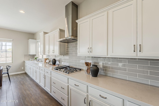 3310 E Los Gatos Dr, Phoenix, AZ 85050 - kitchen featuring stainless steel gas cooktop, wall chimney exhaust hood, baseboards, decorative backsplash, and white cabinetry