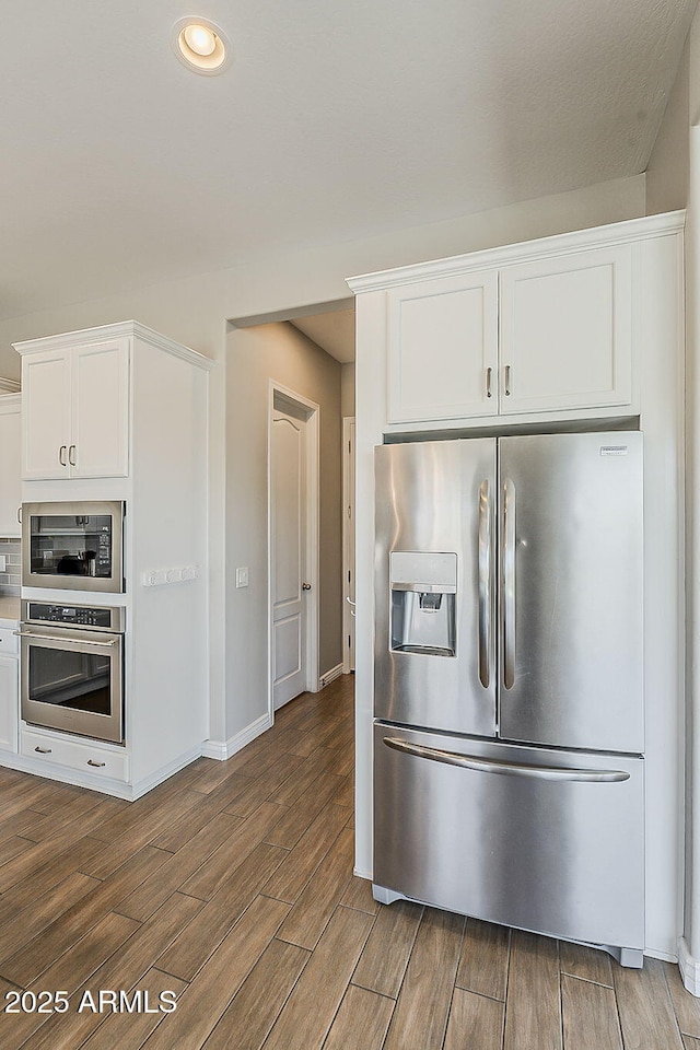 3310 E Los Gatos Dr, Phoenix, AZ 85050 - kitchen featuring stainless steel appliances, dark wood-type flooring, white cabinetry, baseboards, and recessed lighting