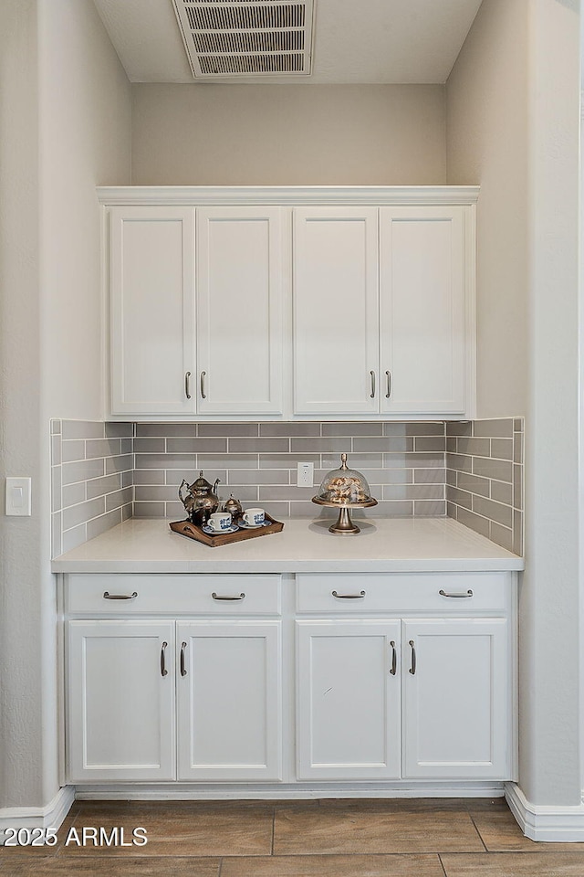3310 E Los Gatos Dr, Phoenix, AZ 85050 - bar area featuring tasteful backsplash, light wood finished floors, and baseboards