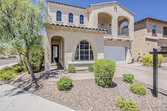 3310 E Los Gatos Dr, Phoenix, AZ 85050 - mediterranean / spanish home with stucco siding, a balcony, an attached garage, a tile roof, and driveway