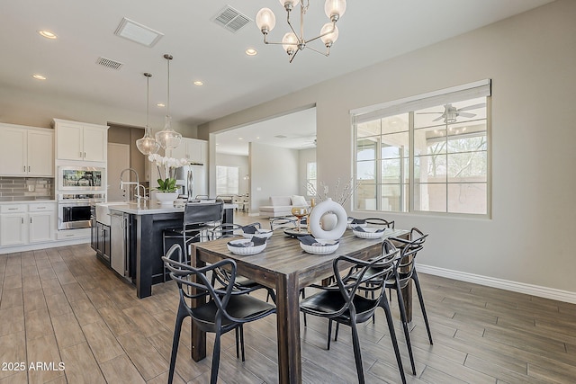 3310 E Los Gatos Dr, Phoenix, AZ 85050 - dining room with a chandelier, light wood-type flooring, baseboards, and recessed lighting