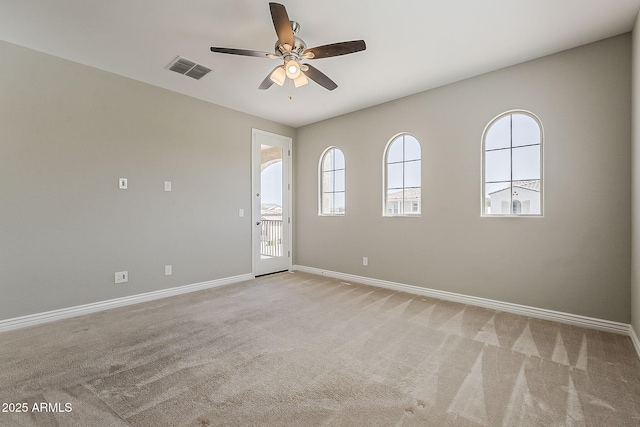 3310 E Los Gatos Dr, Phoenix, AZ 85050 - spare room featuring light carpet, a ceiling fan, and baseboards