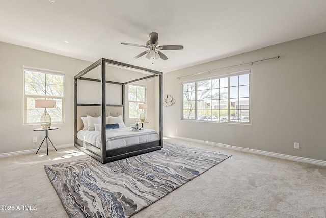 3310 E Los Gatos Dr, Phoenix, AZ 85050 - carpeted bedroom featuring multiple windows, baseboards, and ceiling fan