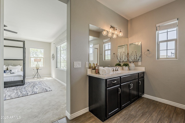 3310 E Los Gatos Dr, Phoenix, AZ 85050 - full bath featuring baseboards, vanity, wood finished floors, and ensuite bath