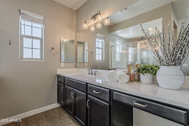 3310 E Los Gatos Dr, Phoenix, AZ 85050 - full bathroom featuring wood finished floors, baseboards, a shower stall, and vanity