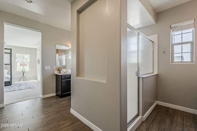 3310 E Los Gatos Dr, Phoenix, AZ 85050 - full bathroom featuring a stall shower, wood finished floors, vanity, and baseboards