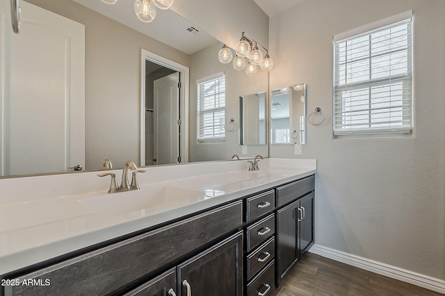 3310 E Los Gatos Dr, Phoenix, AZ 85050 - full bath with baseboards, wood finished floors, and double vanity