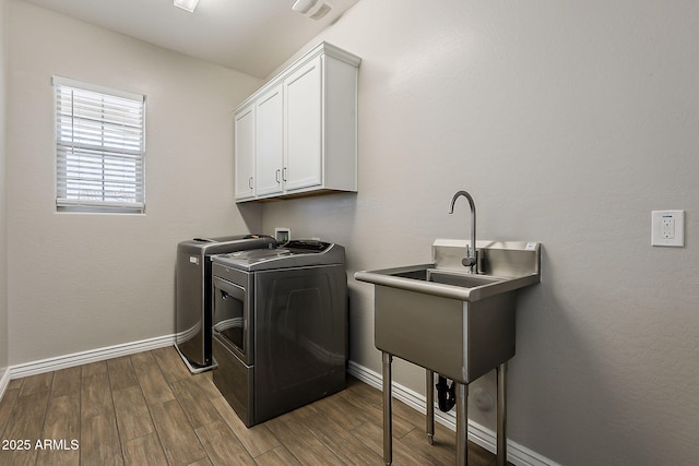 3310 E Los Gatos Dr, Phoenix, AZ 85050 - laundry area with washer and clothes dryer, cabinet space, dark wood-style flooring, and baseboards