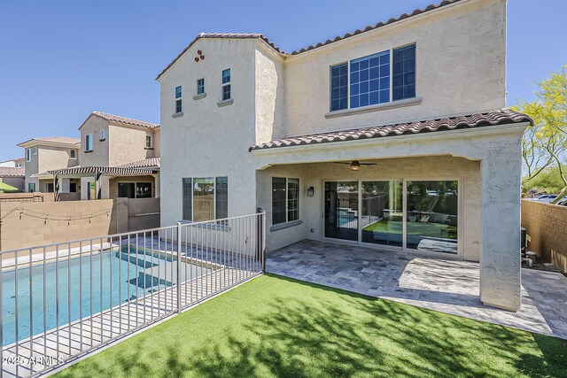 3310 E Los Gatos Dr, Phoenix, AZ 85050 - back of property featuring a tiled roof, a fenced backyard, stucco siding, and a ceiling fan