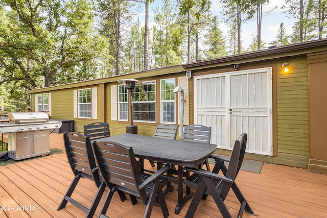 wooden deck with a grill