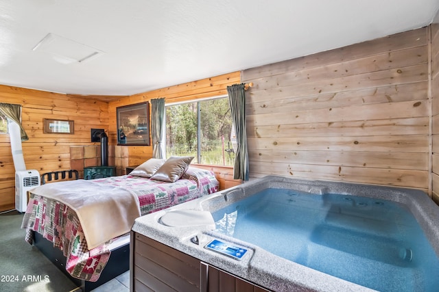 bedroom featuring wood walls and a wood stove