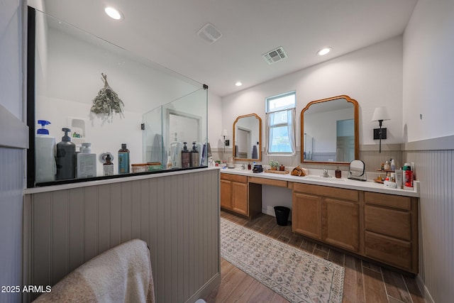 10964 W Garfield St, Avondale, AZ 85323 - full bath with wood finished floors, double vanity, wainscoting, and recessed lighting