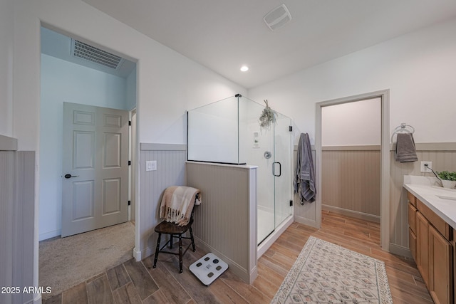 10964 W Garfield St, Avondale, AZ 85323 - full bathroom with wainscoting, wood finished floors, vanity, and a shower stall