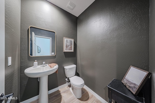 10964 W Garfield St, Avondale, AZ 85323 - bathroom with wood tiled floors and a textured wall