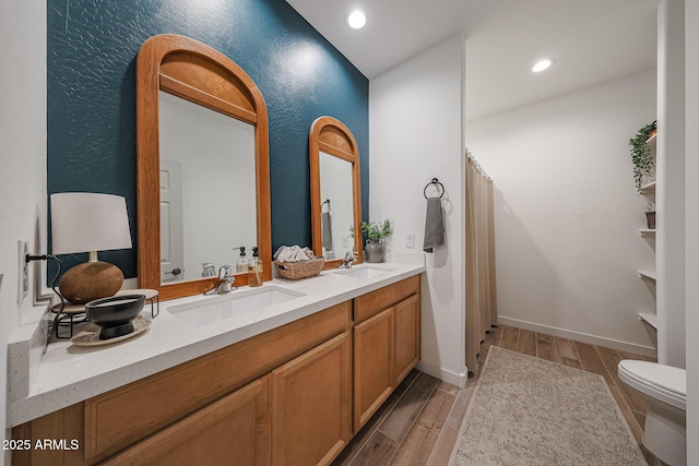 10964 W Garfield St, Avondale, AZ 85323 - bathroom with double vanity, wood finished floors, curtained shower, and recessed lighting