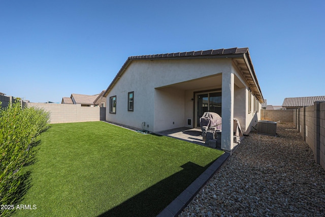 10964 W Garfield St, Avondale, AZ 85323 - rear view of house with stucco siding, a fenced backyard, and a patio