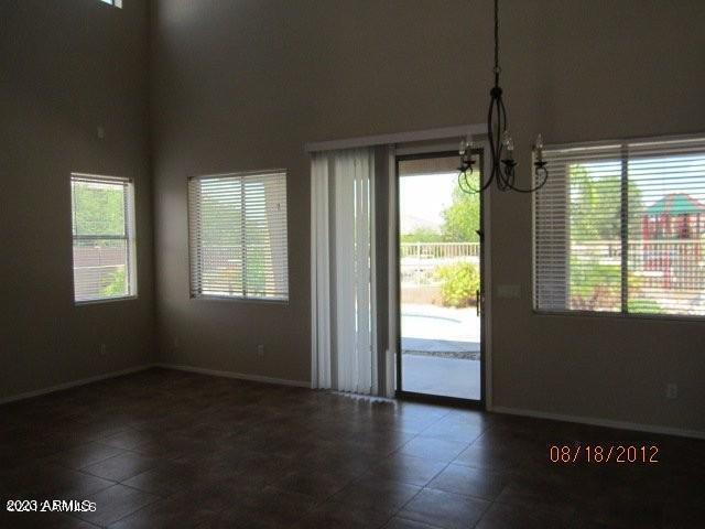 9018 W Superior Ave, Tolleson, AZ 85353 - unfurnished dining area with a chandelier and tile patterned flooring