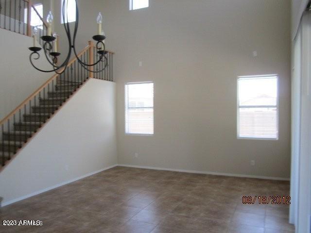 9018 W Superior Ave, Tolleson, AZ 85353 - stairway featuring plenty of natural light, a chandelier, and a high ceiling