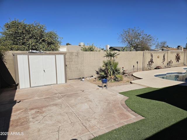 view of patio / terrace with a fenced in pool and a storage shed