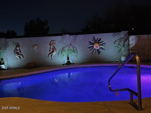 view of pool at night