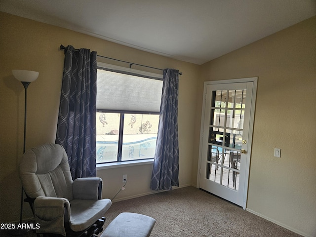 living area featuring a wealth of natural light, carpet flooring, and lofted ceiling