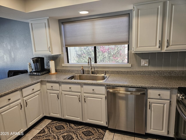 kitchen featuring sink, white cabinets, light tile patterned floors, and stainless steel appliances