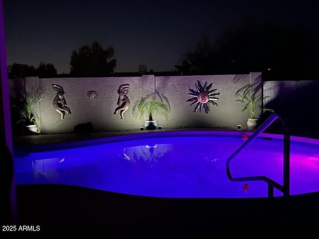 view of pool at night