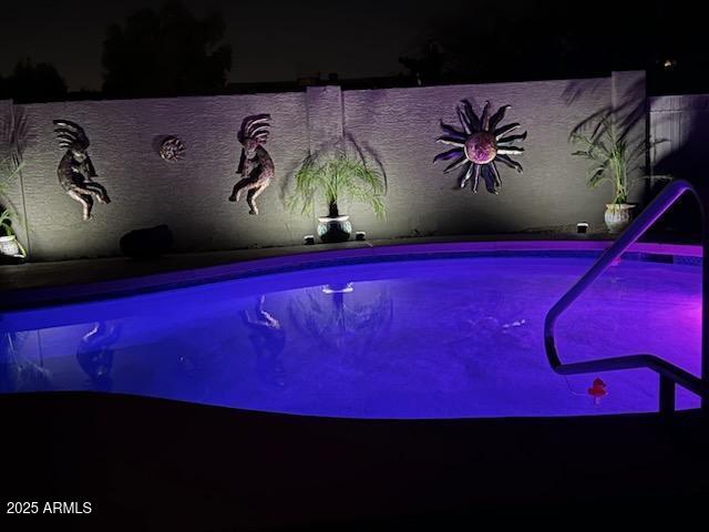 view of pool at night