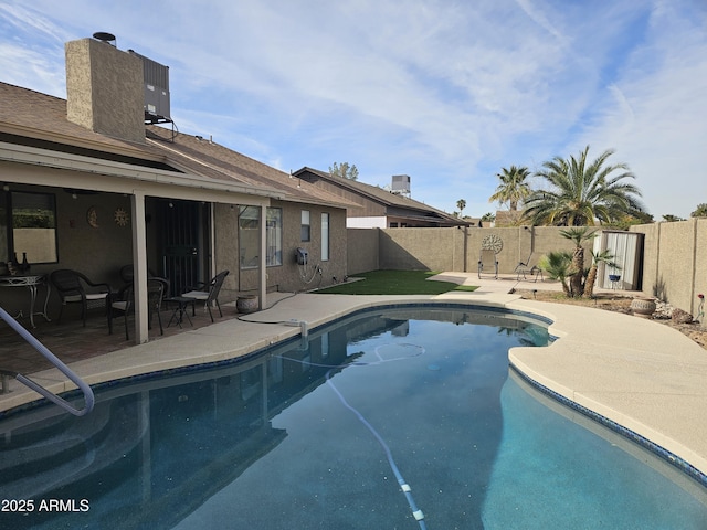 view of swimming pool with a patio area and central AC unit