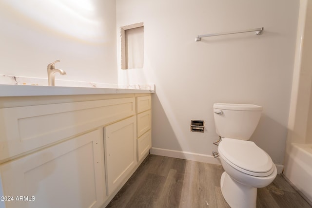 bathroom with vanity, toilet, and hardwood / wood-style flooring