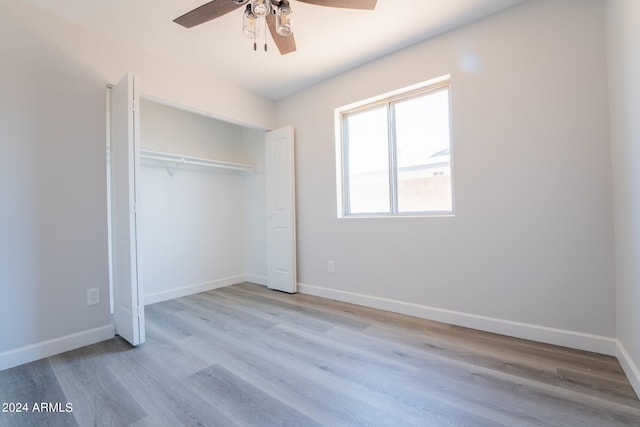 unfurnished bedroom featuring light hardwood / wood-style flooring, a closet, and ceiling fan