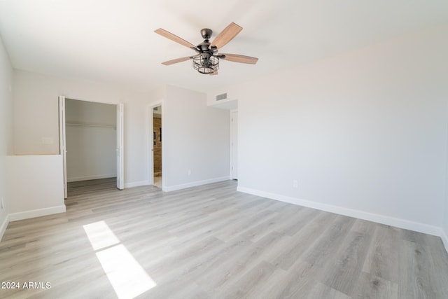 spare room featuring light hardwood / wood-style floors and ceiling fan