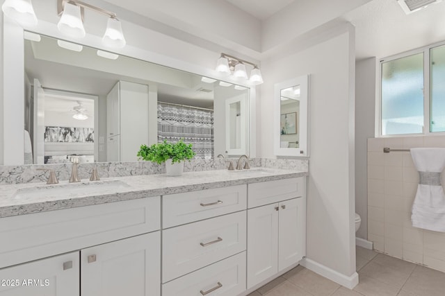 bathroom with vanity, tile patterned floors, ceiling fan, and toilet