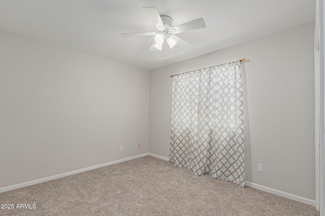 carpeted spare room featuring ceiling fan