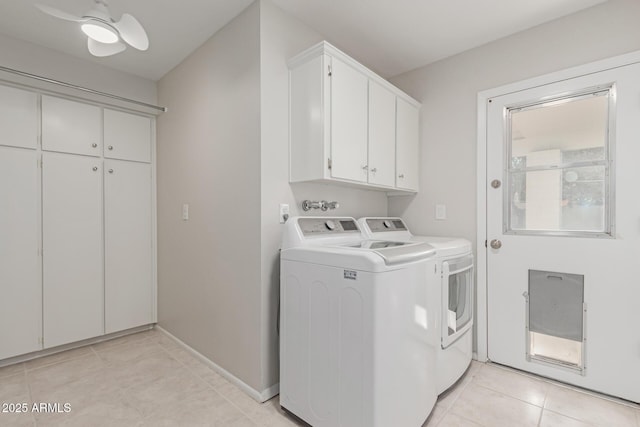 laundry area featuring light tile patterned flooring, cabinets, washer and clothes dryer, and ceiling fan